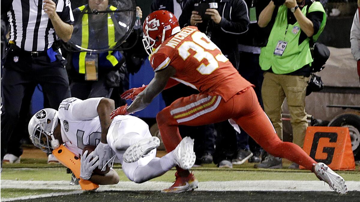 Raiders receiver Michael Crabtree catches a touchdown pass in front of Chiefs cornerback Terrance Mitchell at the end of the game to tie the score before winning on the conversion kick.
