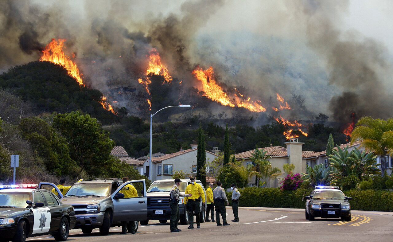 Fire consumes a hillside above La Moree Road in San Marcos as crews continue to battle the Cocos fire.