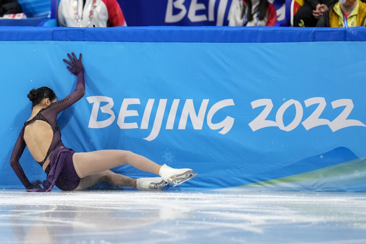 Zhu Yi, of China, falls in the women's short program team figure skating competition at the 2022 Winter Olympics, Sunday, Feb. 6, 2022, in Beijing. (AP Photo/Natacha Pisarenko)
