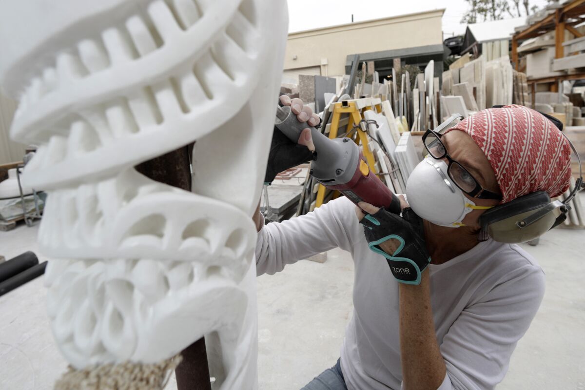 Elizabeth Turk works on a sculpture at her marble studio in Santa Ana.