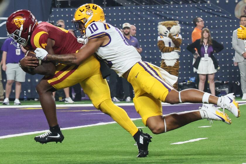 Las Vegas, Nevada, Sunday, September 1, 2024 - USC Trojans running back Woody Marks (4) carries LSU Tigers safety Dashawn Spears (10) into the end zone for the winning score in the last seconds of the game at the Modelo Vegas Kickoff Classic at Allegiant Stadium. (Robert Gauthier/Los Angeles Times)