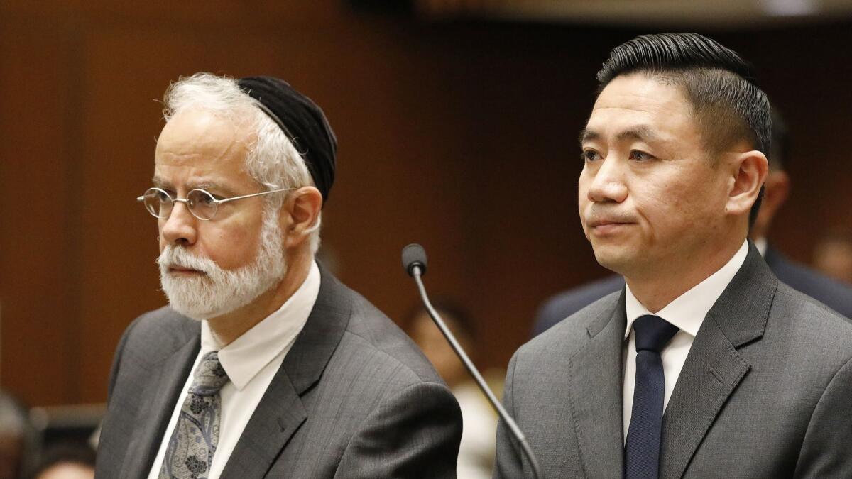 Los Angeles County Sheriff's Deputy Luke Liu, right, appears with his attorney, Michael D. Schwartz, in a downtown courthouse in 2018. Liu was ordered to stand trial for voluntary manslaughter.