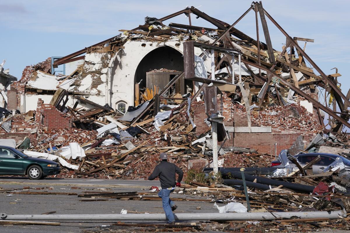 People survey damage from a tornado in Mayfield, Ky., on Dec. 11.