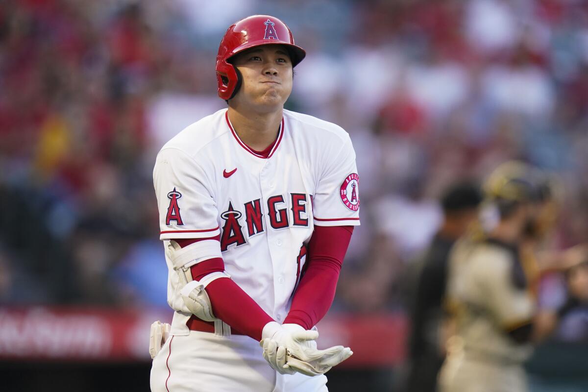 Shohei Ohtani grimaces after getting hit by a pitch on Saturday.