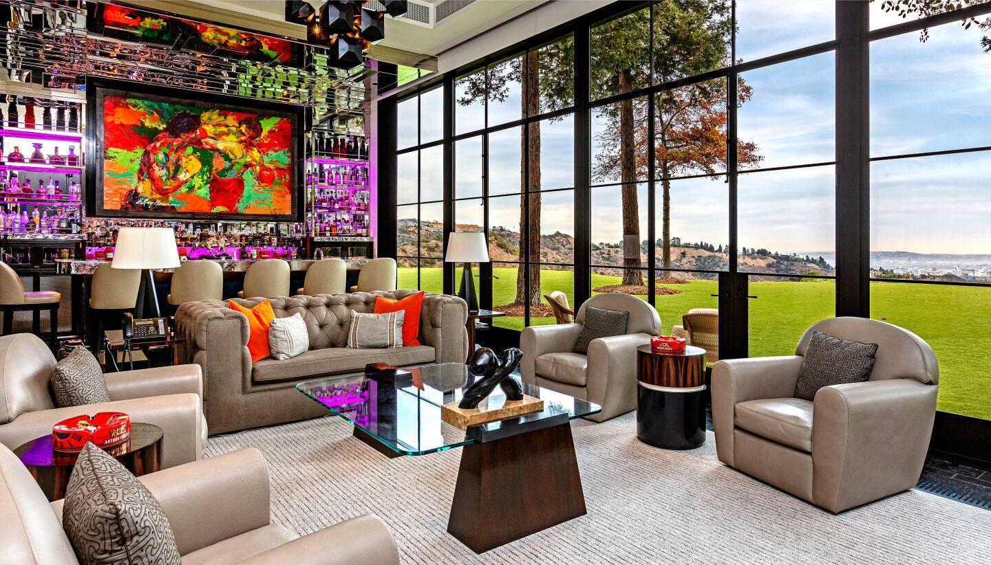 Sylvester Stallone's 21,000-square-foot showplace features knockout views and Rocky statues: one in the memorabilia room and one overlooking the infinity pool out back.