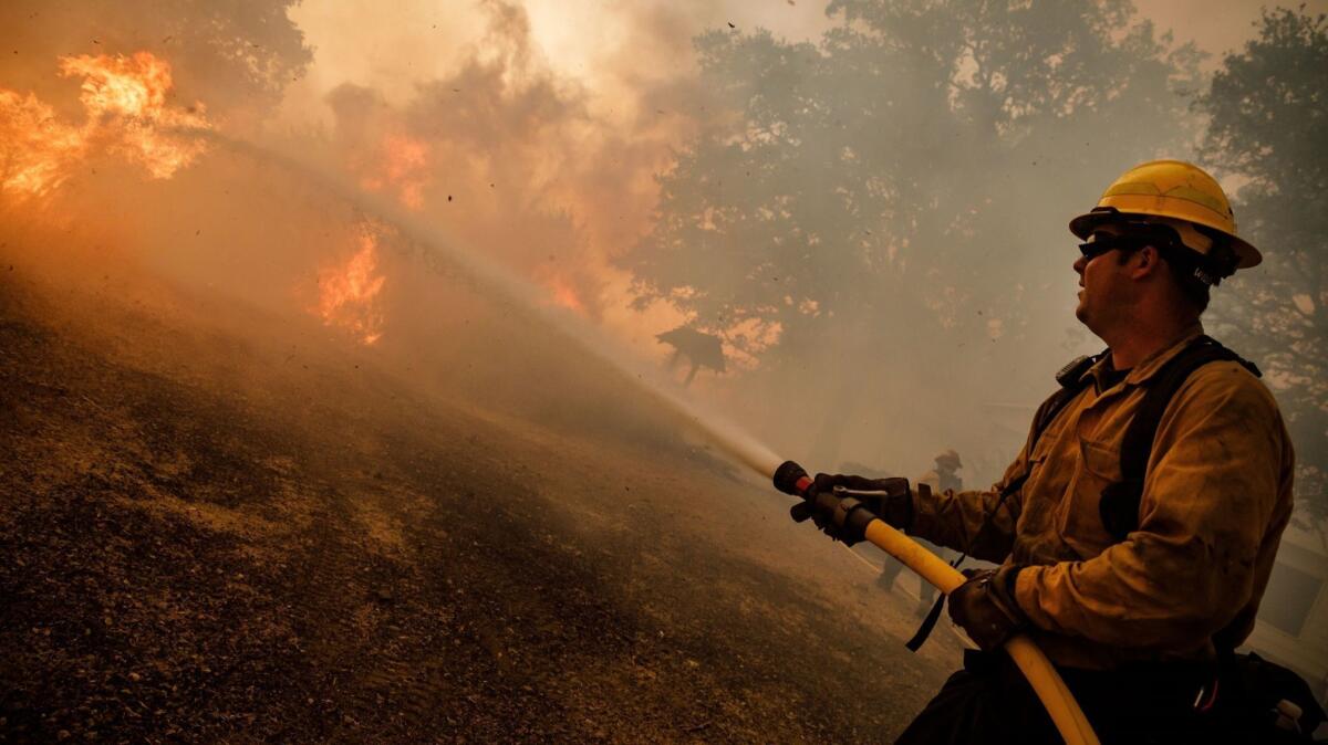Verizon slowed critical internet service during a recent wildfire battle, according to the Santa Clara County Fire Department. Here, a firefighter battles the Mendocino Complex fire in July.
