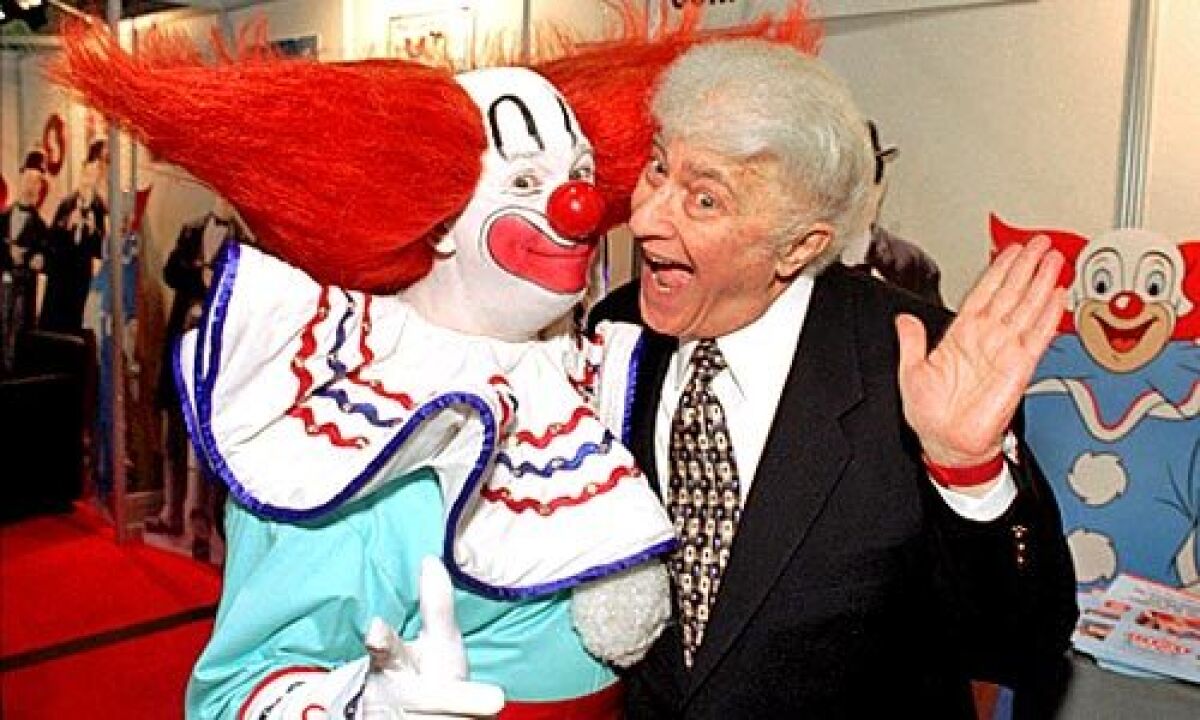 Harmon with a Bozo performer in 1996 at the National Assn. of Television Program Executives convention in Las Vegas.