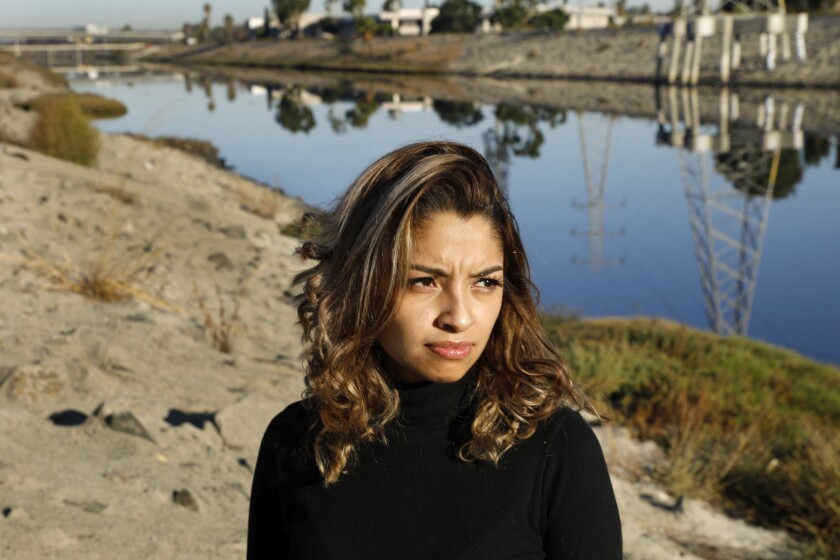 Closeup of a woman with a backdrop of a canal.