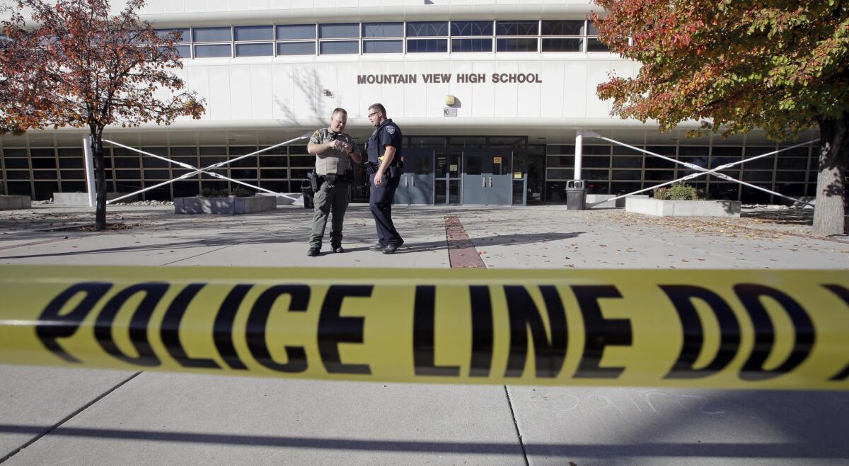 Police stand outside Mountain View High School in Orem, Utah, after several students were stabbed Tuesday.