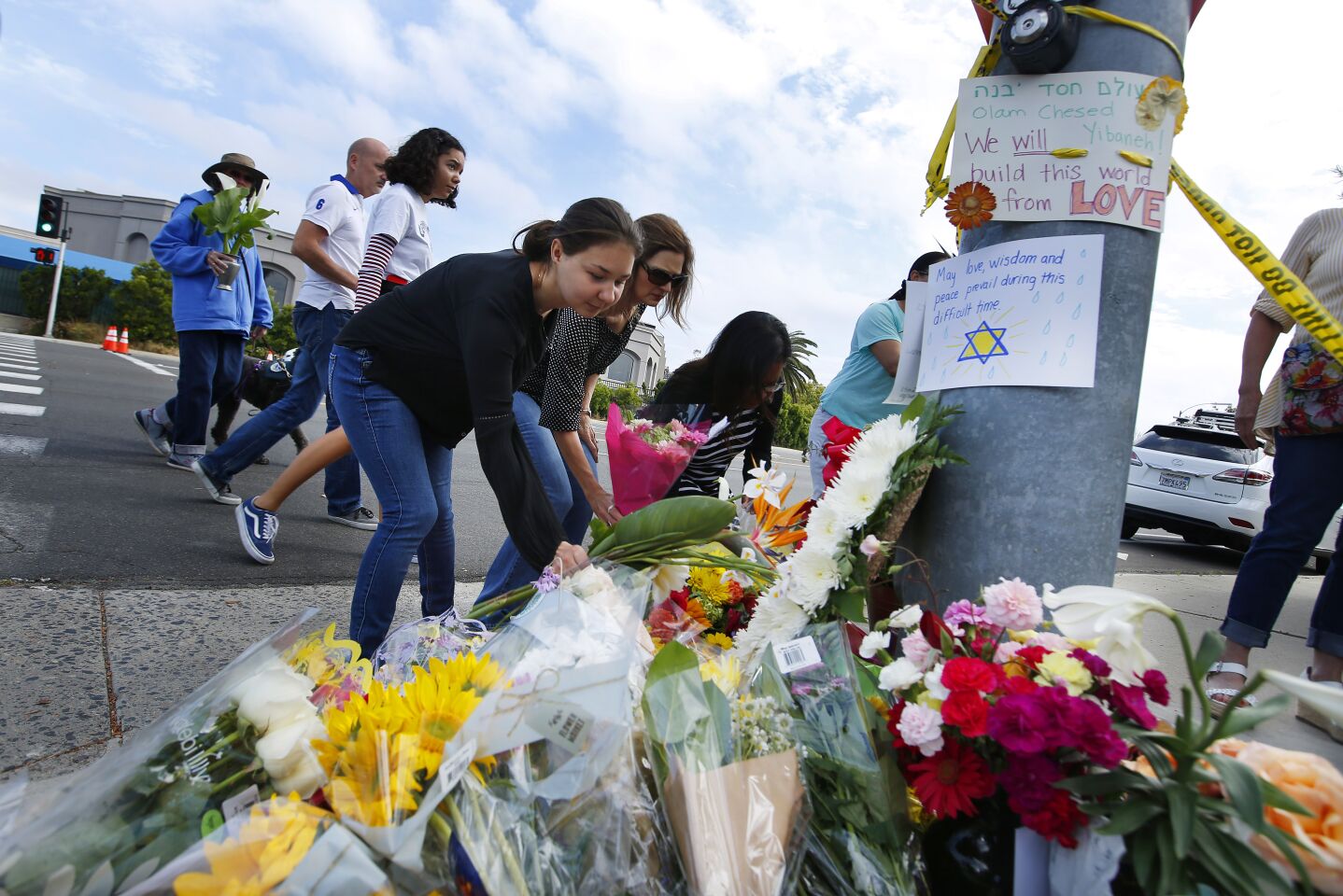 Poway residents leave flowers at a memorial across the street from the Chabad of Poway, where a shooting took place the day before on April 28, 2019 in Poway, California. (Photo by K.C. Alfred/The San Diego Union-Tribune)