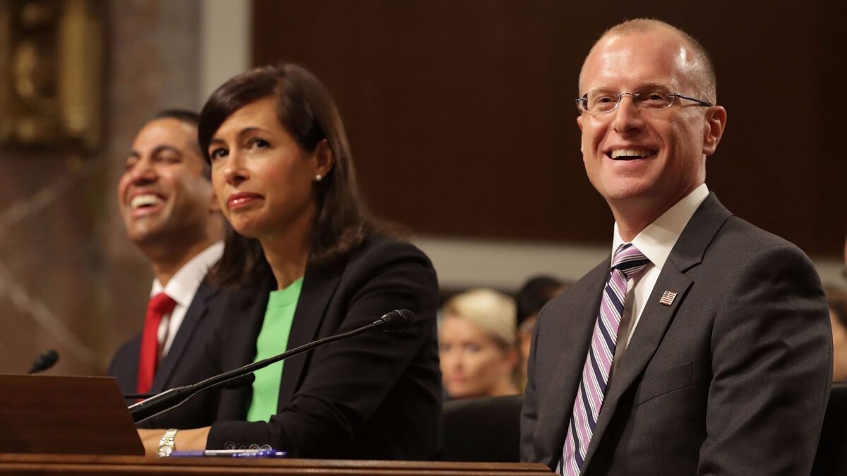 Brendan Carr, right, along with Jessica Rosenworcel and FCC Chairman Ajit Pai, at a Senate confirmation hearing in July.