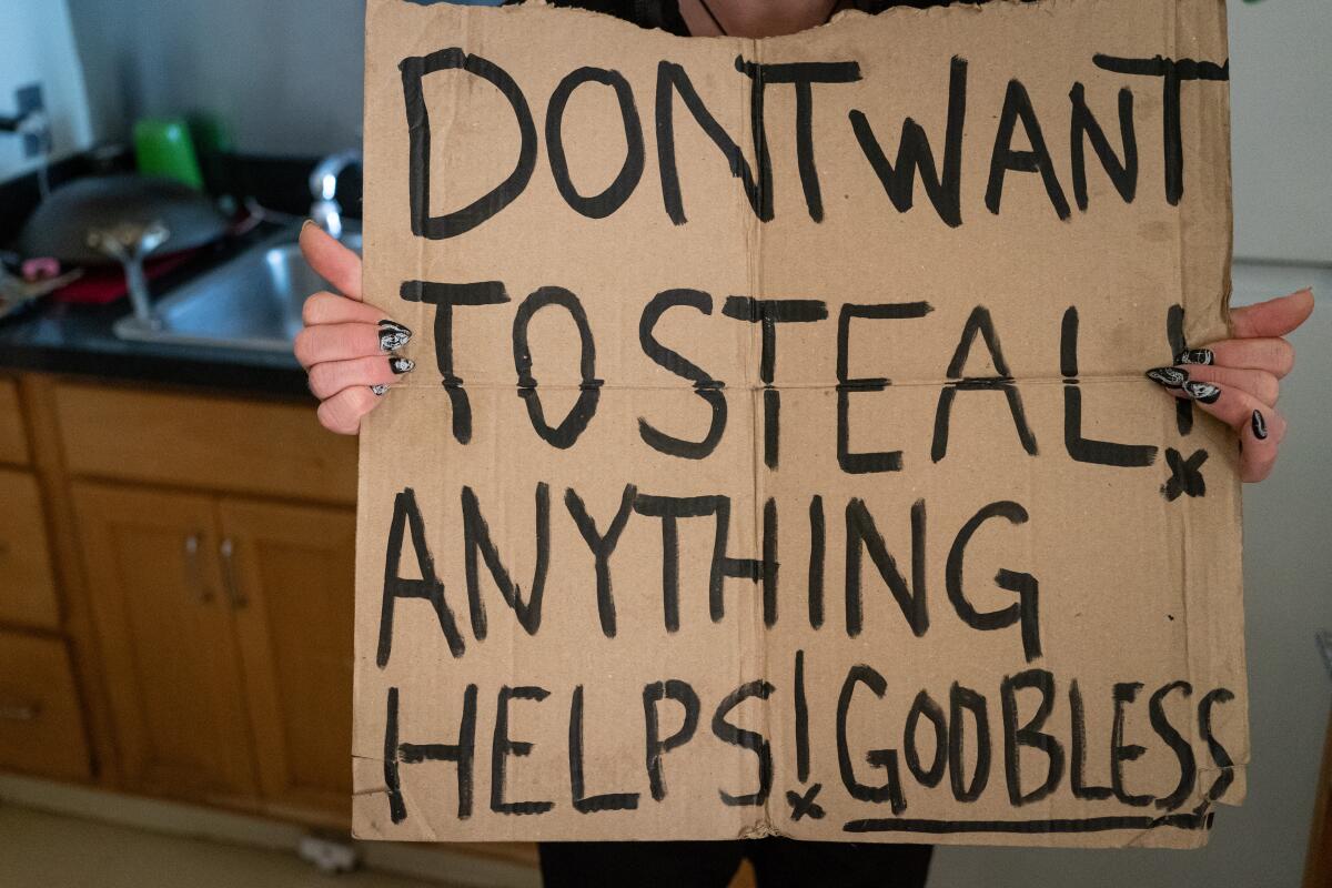 A cardboard sign reads: Don't want to steal! Anything helps! God bless.