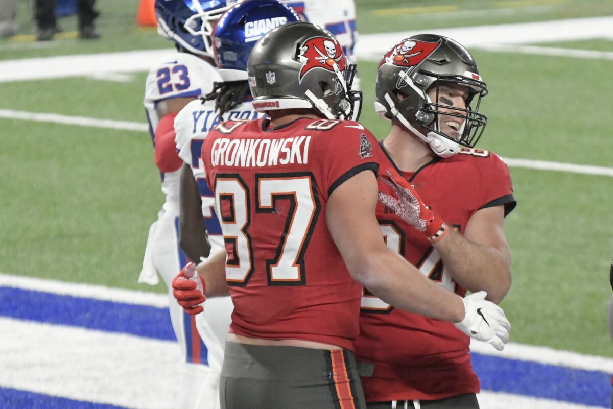 Tampa Bay Buccaneers' Rob Gronkowski (87), left, celebrates his touchdown with Cameron Brate during the second half of an NFL football game against the New York Giants, Monday, Nov. 2, 2020, in East Rutherford, N.J. (AP Photo/Bill Kostroun)