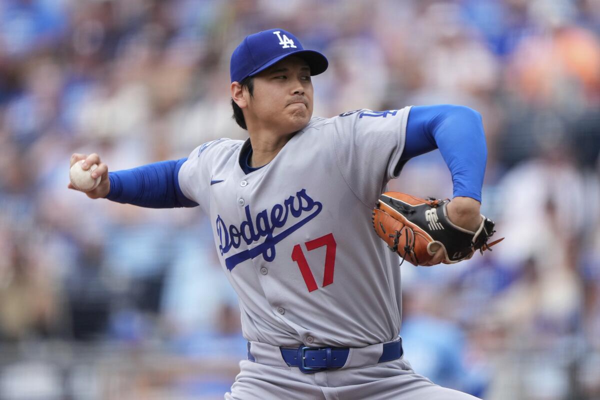 Dodgers star Shohei Ohtani rears back as he delivers a pitch against the Royals on Sunday.