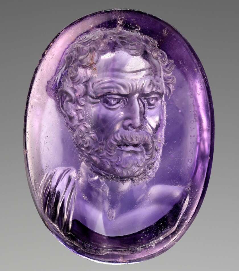 A tiny, inch-high amethyst carved with a bust of Demosthenes.