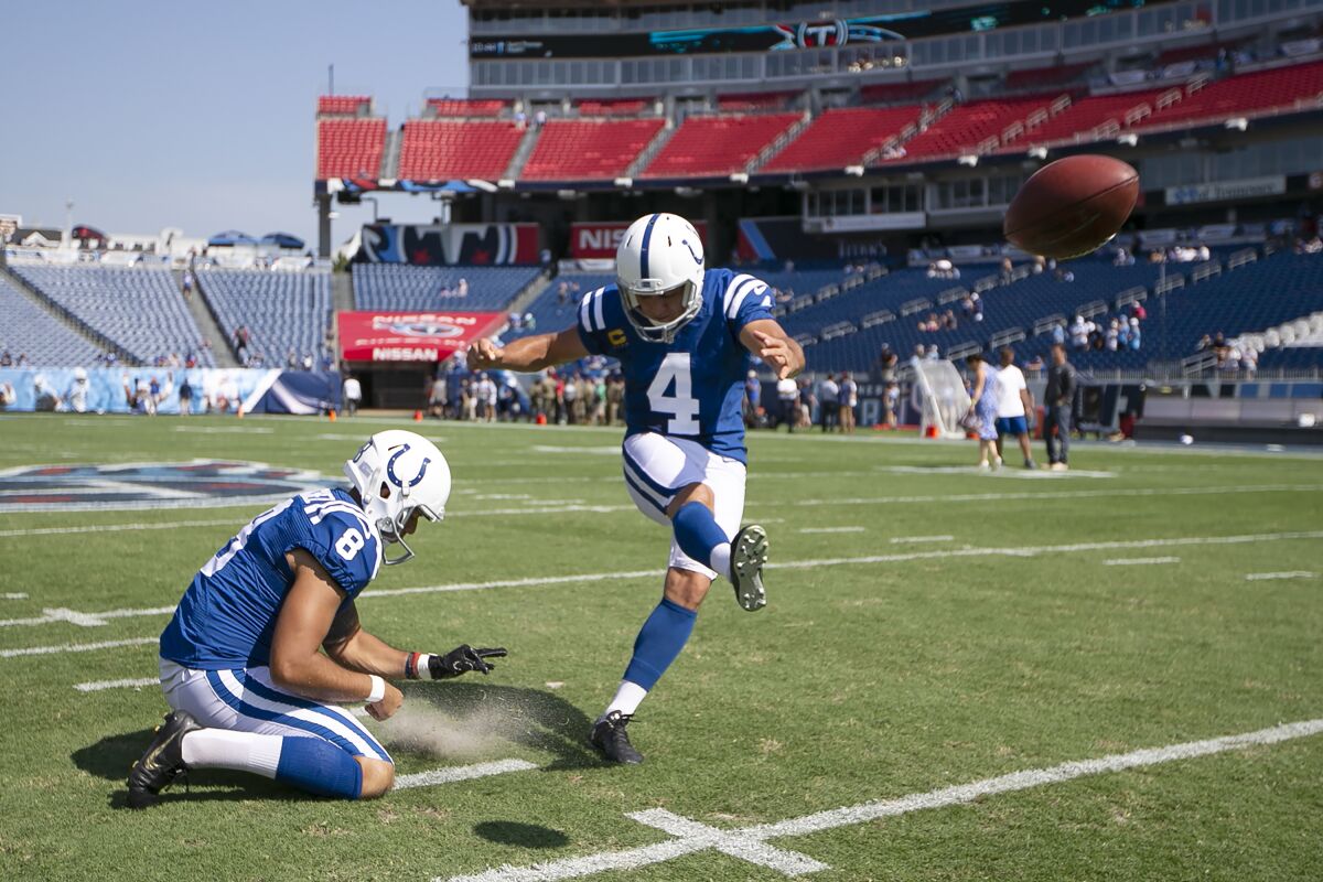 Adam Vinatieri warms up with holder Rigoberto Sanchez before Sunday's game.