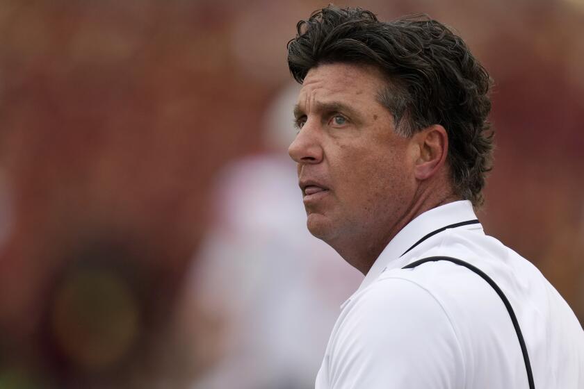 Oklahoma State head coach Mike Gundy watches from the sideline during the first half of a game against Iowa State