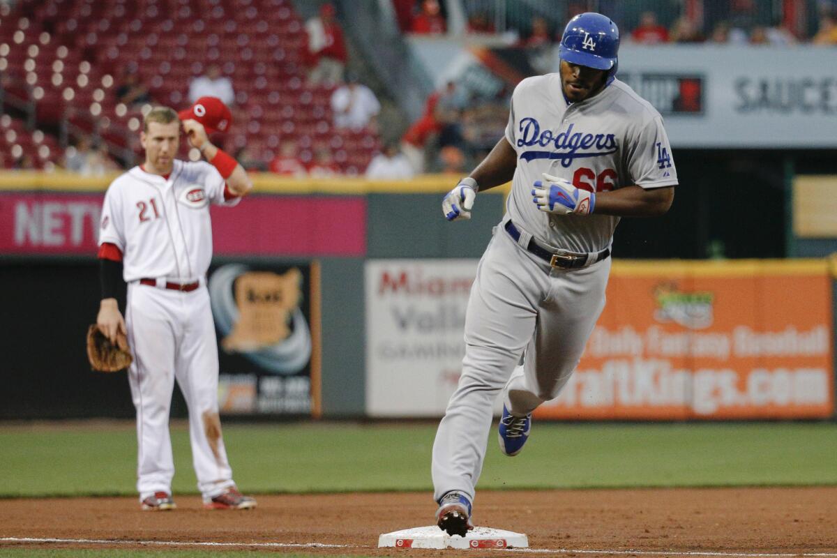 Dodgers outfielder Yasiel Puig rounds third base on a two-run home run against the Reds during a game Wednesday in Cincinnati.