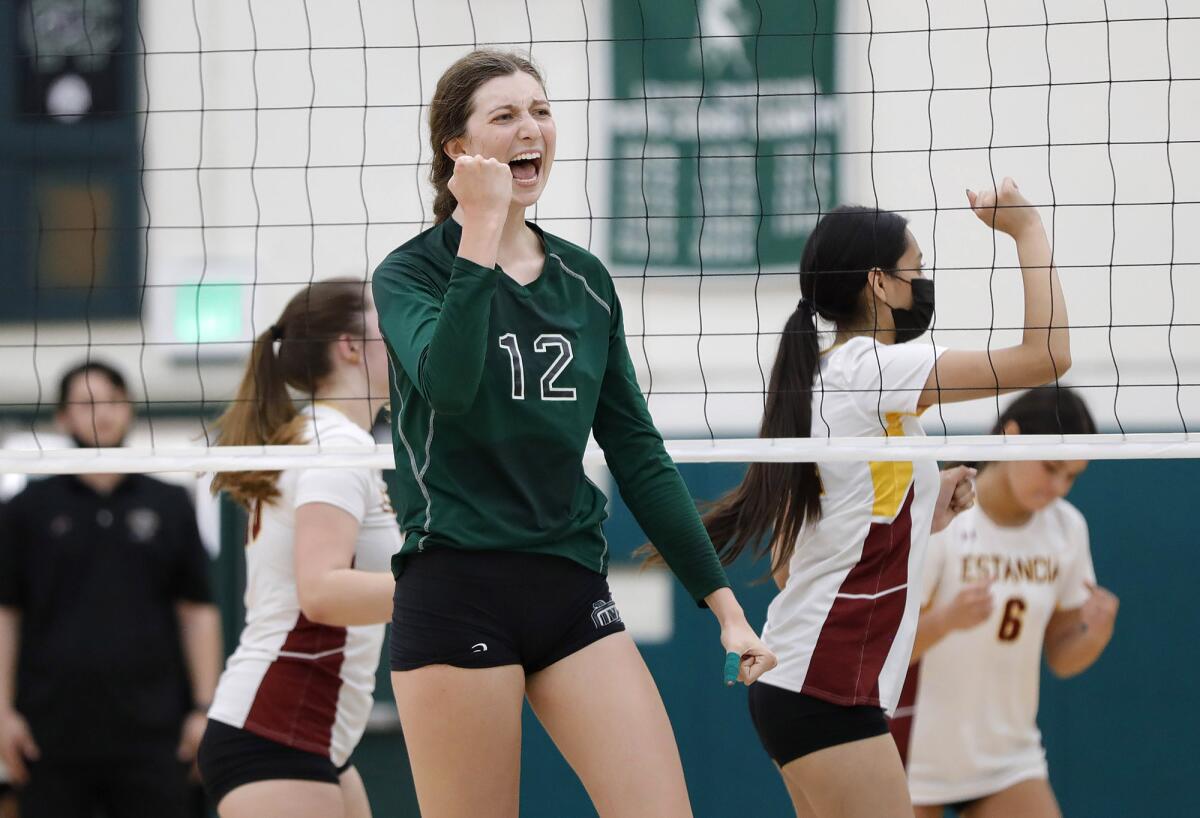 Costa Mesa's Lorelei Hobbis (12) reacts to a point after a long rally against Estancia on Sept. 23.