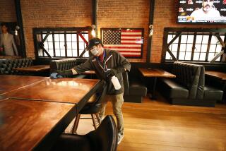 SAN LUIS OBISPO, CA - MARCH 03: Chris Finefrock sanitizes the bar as part of the sanitation team cleaning the Finney's Crafthouse & Kitchen in downtown San Luis Obispo as they prepare to open for indoor dinning as San Luis Obispo county moved into the red tier that allows for indoor dining and gym reopening. The Finefrock family owned business has four locations in Southern California. Chris said, "We clean and sanitize each location so customers can feel comfortable inside." downtown on Wednesday, March 3, 2021 in San Luis Obispo, CA. (Al Seib / Los Angeles Times).