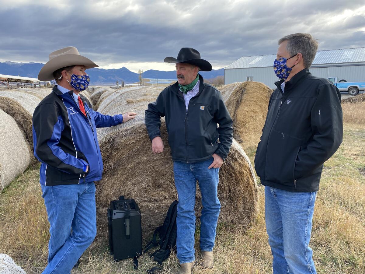 Sen. Steve Daines (R-Mont.), right, visits with ranchers John Grande, left, and Craig Morgan near Bozeman.