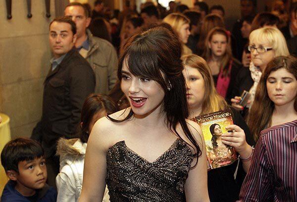 Lily Collins is surrounded by her young fans at a party after the premiere of "Mirror Mirror." Collins, the daughter of singer Phil Collins, has her first leading role as Snow White in the film.