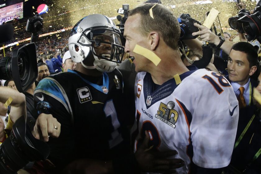 Denver Broncos' Peyton Manning, right, greets Carolina Panthers' Cam Newton after Super Bowl 50.