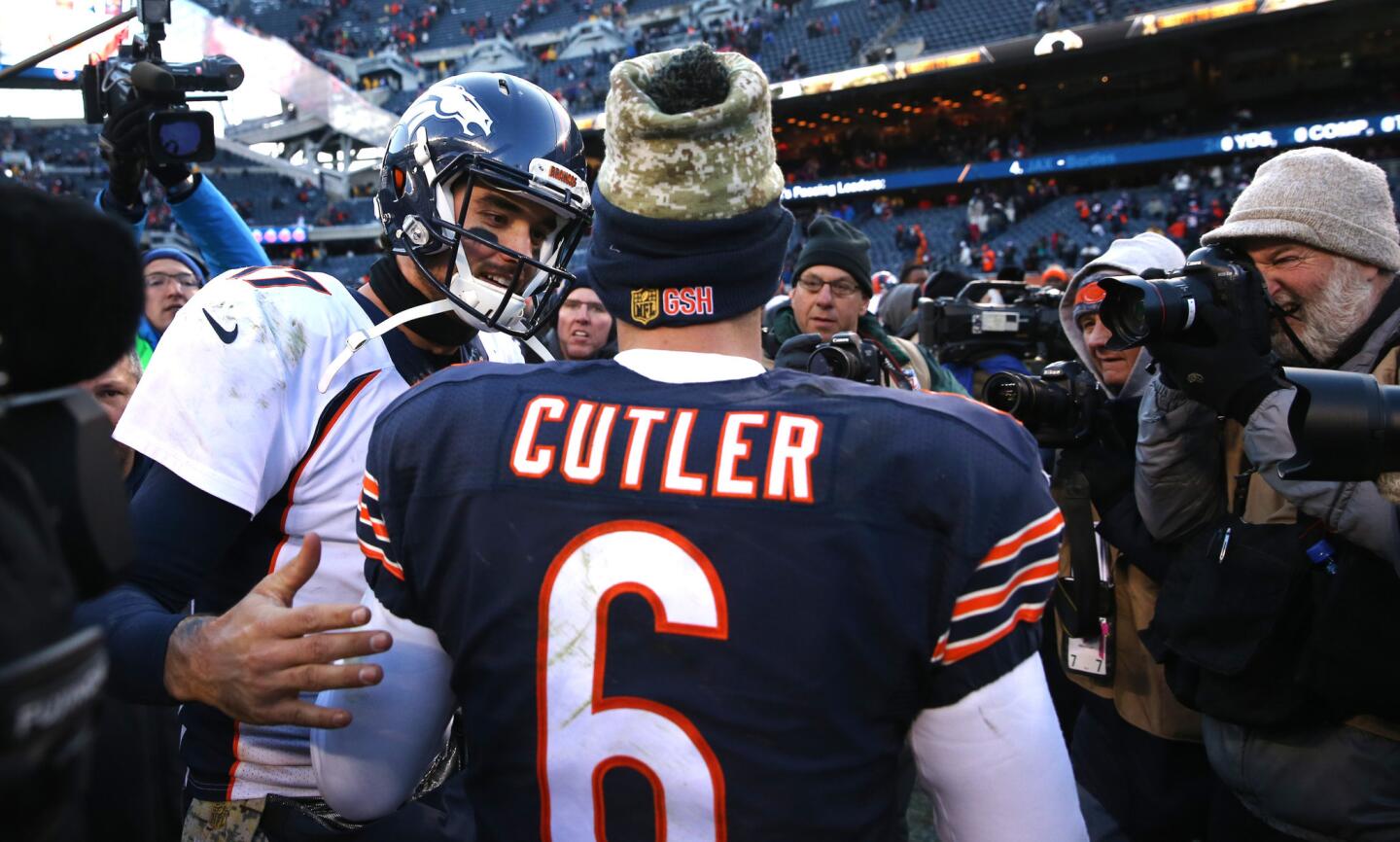 Denver Broncos quarterback Brock Osweiler and Chicago Bears quarterback Jay Cutler greet one another after a Bears loss at Soldier Field in Chicago on Sunday, Nov. 22, 2015.