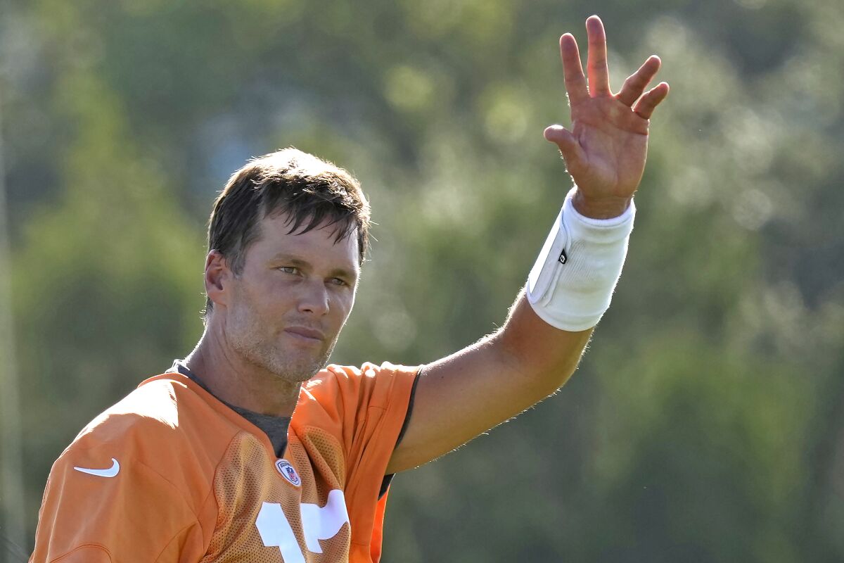 Tampa Bay Buccaneers quarterback Tom Brady waves to the fans during an NFL football training camp practice Wednesday, July 27, 2022, in Tampa, Fla. (AP Photo/Chris O'Meara)