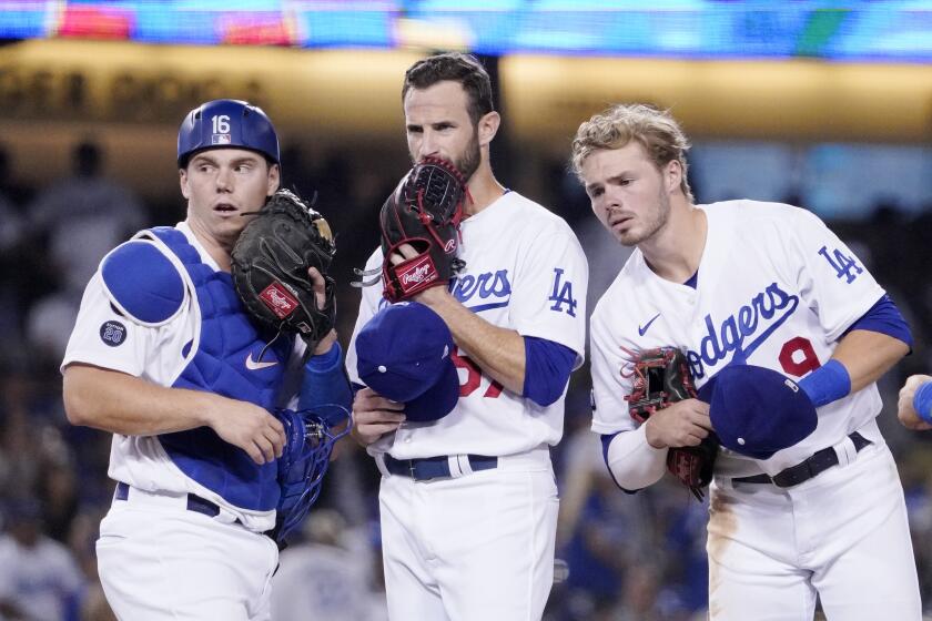 Los Angeles Dodgers catcher Will Smith, left, Los Angeles Dodgers' Jake Reed, center, and shortstop baseman Gavin Lux.
