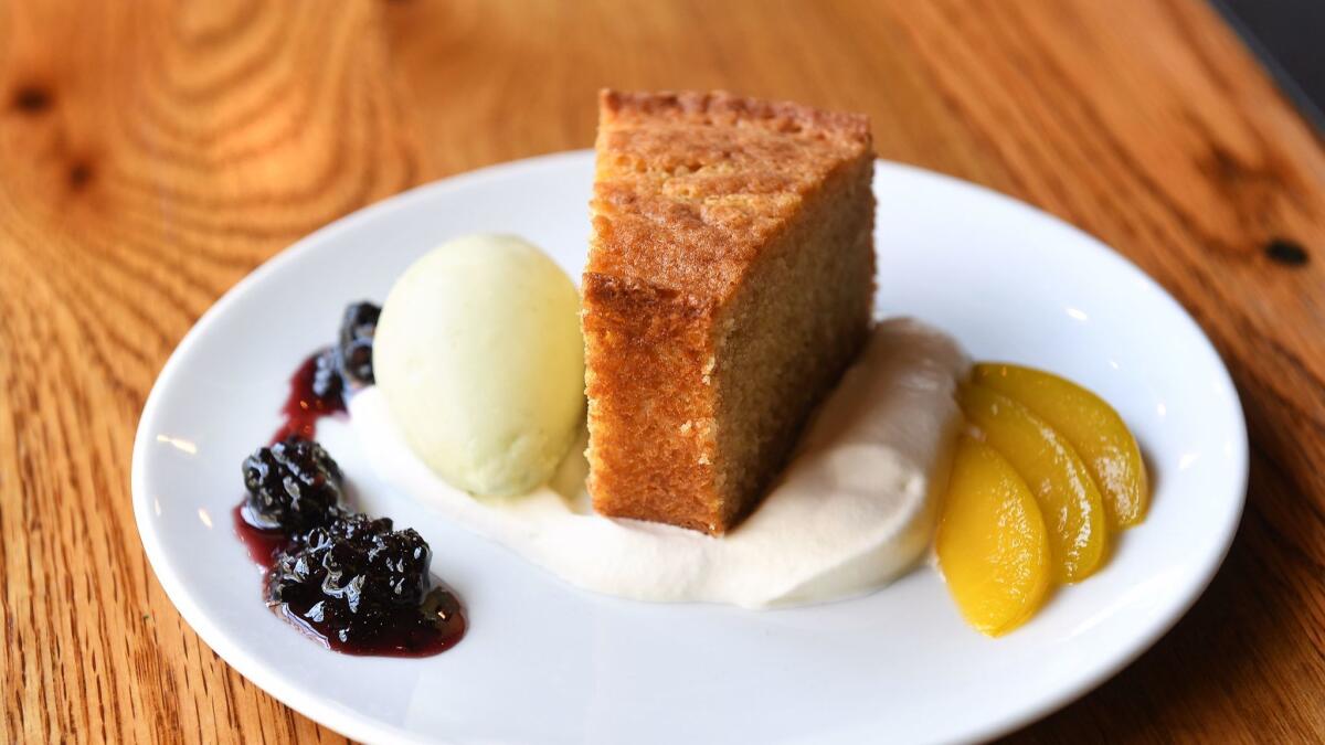 Einkorn buttermilk cake with lemon verbena and lemon sherbet, fermented blackberry jam and emerald plums is on the menu at Bestia in Los Angeles. (Christina House / For The Times)
