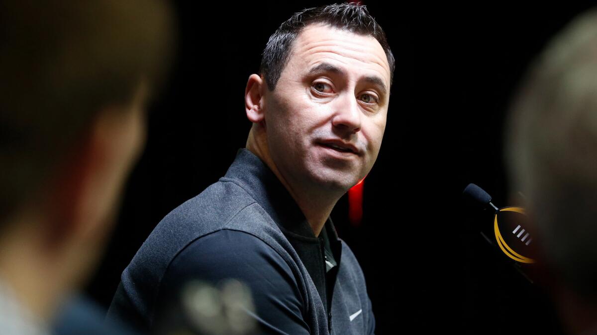 Steve Sarkisian listens to a question during a media session for the College Football Playoff championship game.