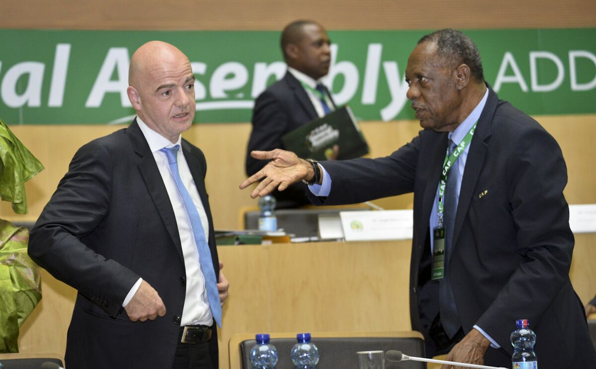 FILE - Issa Hayatou, right, speaks to FIFA President Gianni Infantino, left, at the opening of the general assembly of the Confederation of African Football (CAF) in Addis Ababa, Ethiopia, Thursday, March 16, 2017. Long-time African soccer leader Issa Hayatou won an appeal ruling Saturday, Feb. 5, 2022, to overturn a one-year ban for alleged commercial wrongdoing imposed by FIFA where he was once interim president. The Court of Arbitration for Sport said it upheld Hayatou's appeal because “there was insufficient evidence” of misconduct in a Confederation of African Football marketing and media rights deal. (AP Photo, File)