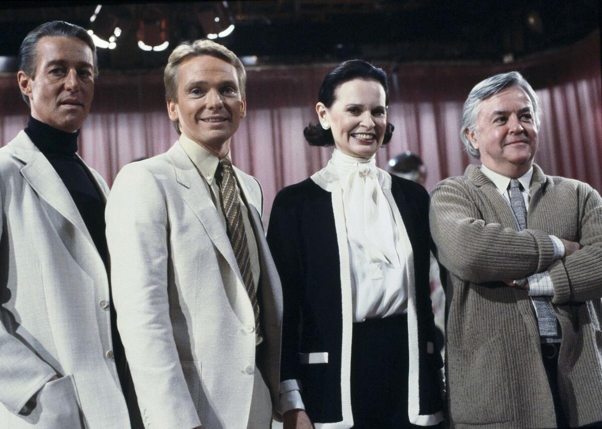 Three men and a woman on a TV show set