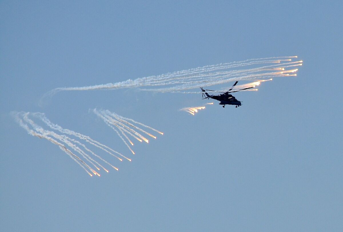 A Russian combat helicopter spreads anti-missile flares during a drill outside the southern Russian city of Rostov-on-Don on Friday. Moscow announced wider-scale exercises on Monday that will involve more than 100 combat aircraft in drills near the Ukrainian border.