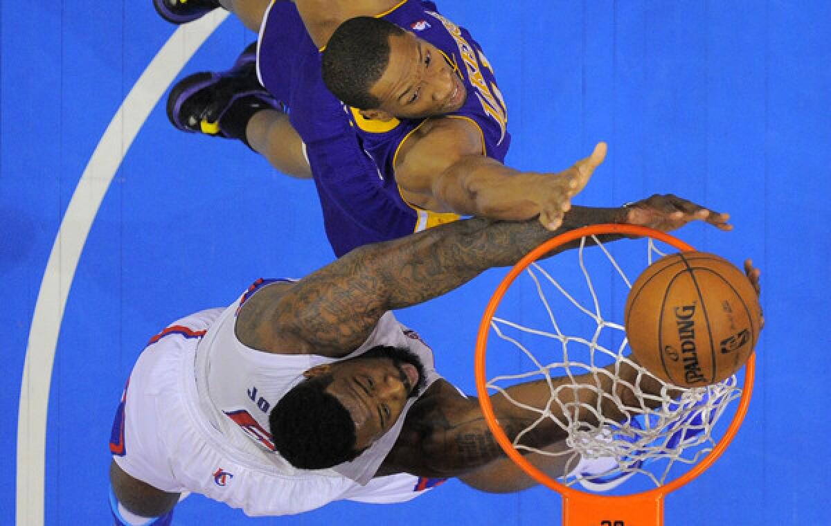 Clippers center DeAndre Jordan, bottom, shoots over Lakers forward Wesley Johnson during the Clippers' win Jan. 10. The teams meet again Thursday.