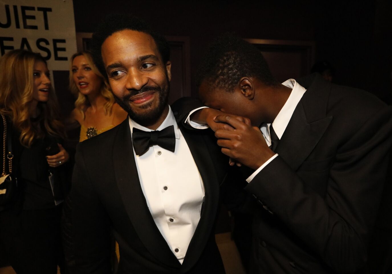 "Moonlight" actors Andre Holland, left, and Ashton Sanders backstage during the Academy Awards telecast on Feb. 26.