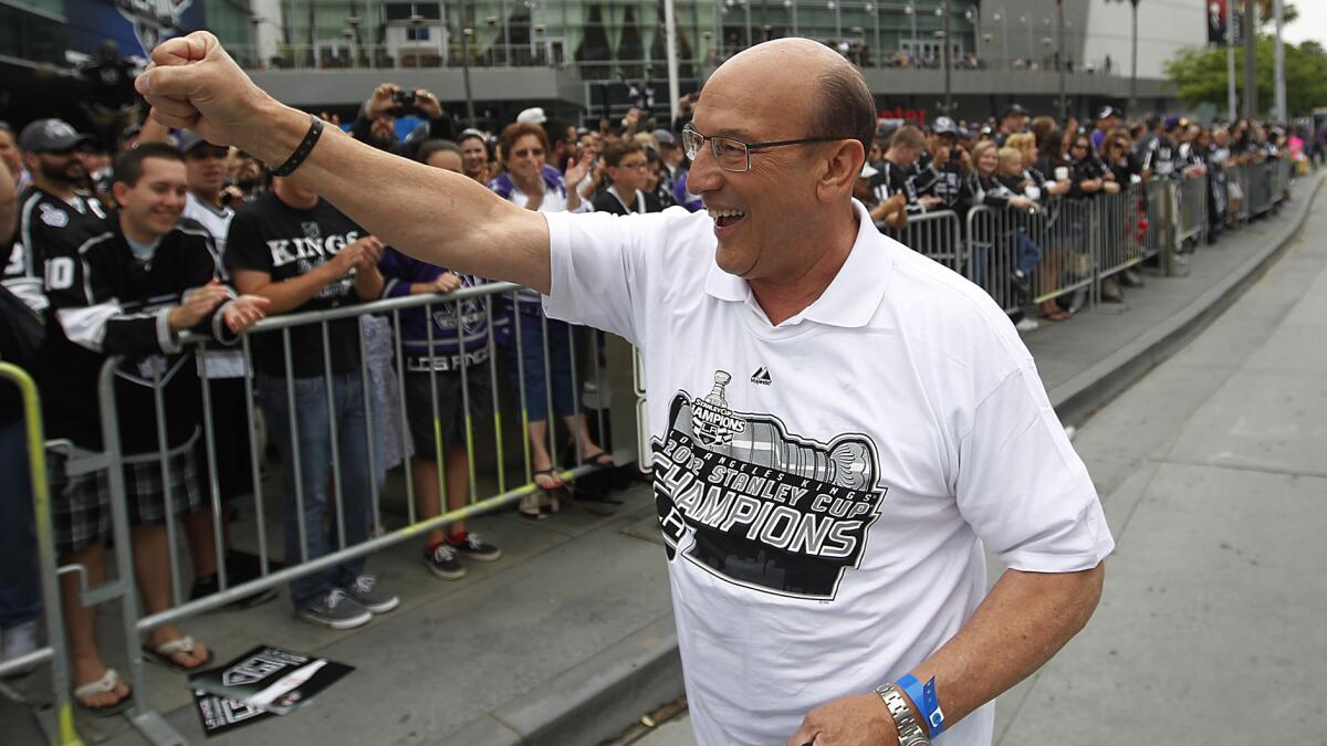 Kings broadcaster Bob Miller celebrates with fans during the team's Stanley Cup parade in downtown Los Angeles in June.