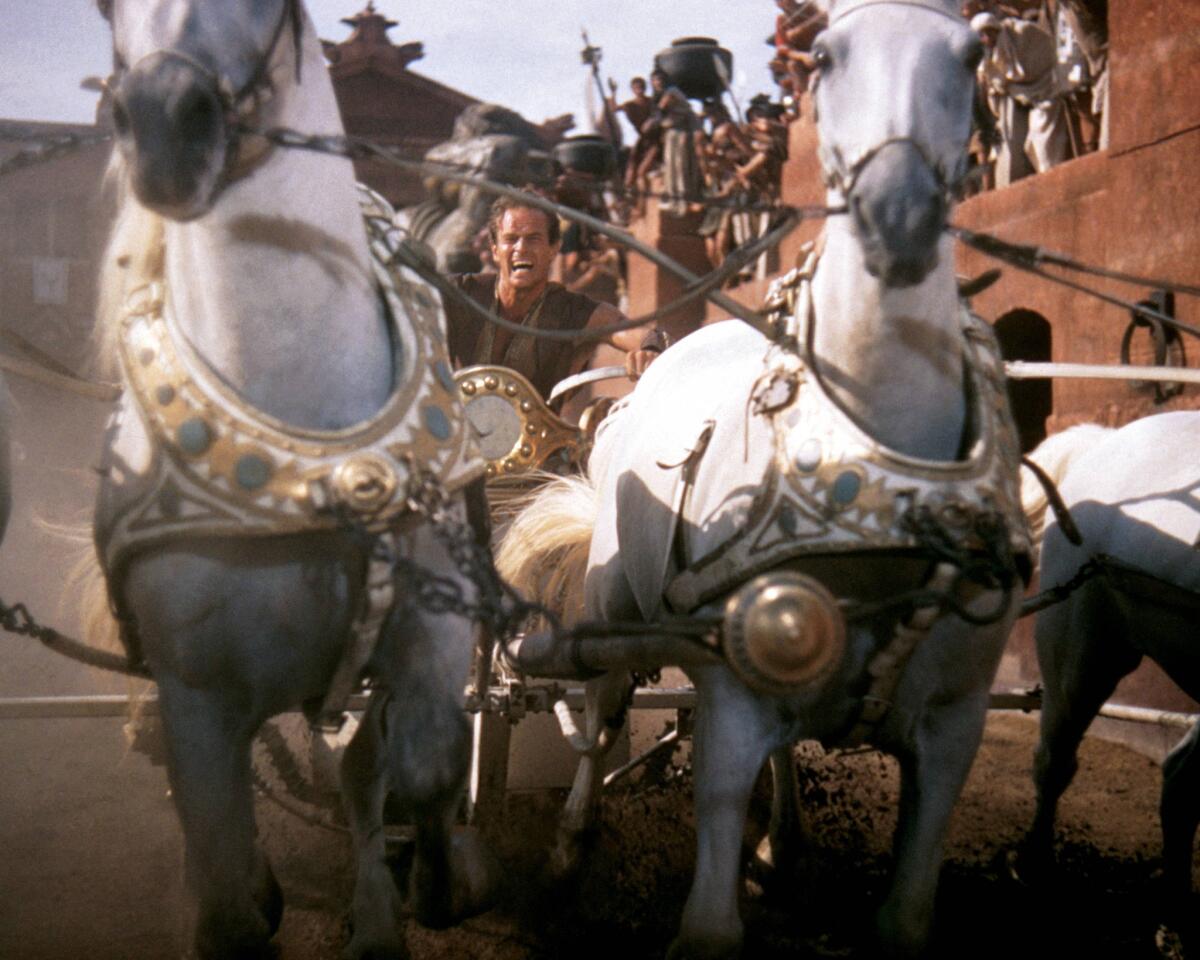 Charlton Heston in costume and riding a horsedrawn chariot in a publicity still for the 1959 film "Ben-Hur."