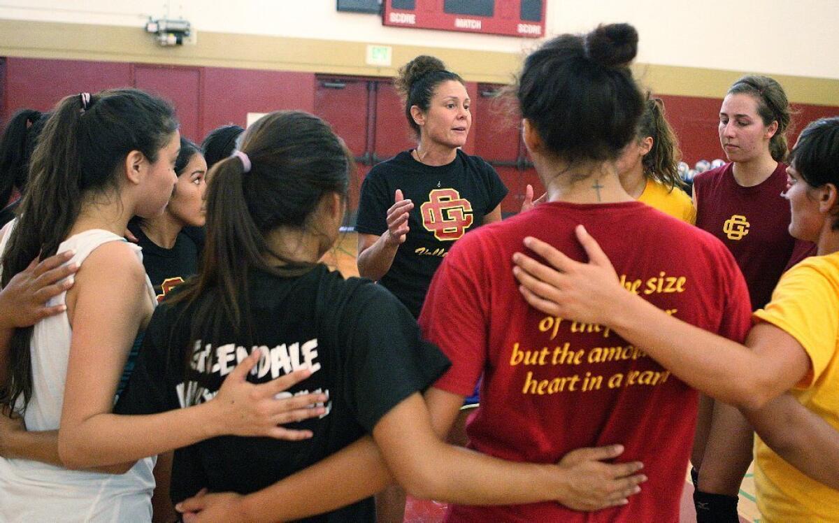 Glendale Community College women's volleyball Coach Yvette Ybarra, center, coaches her team during a practice.