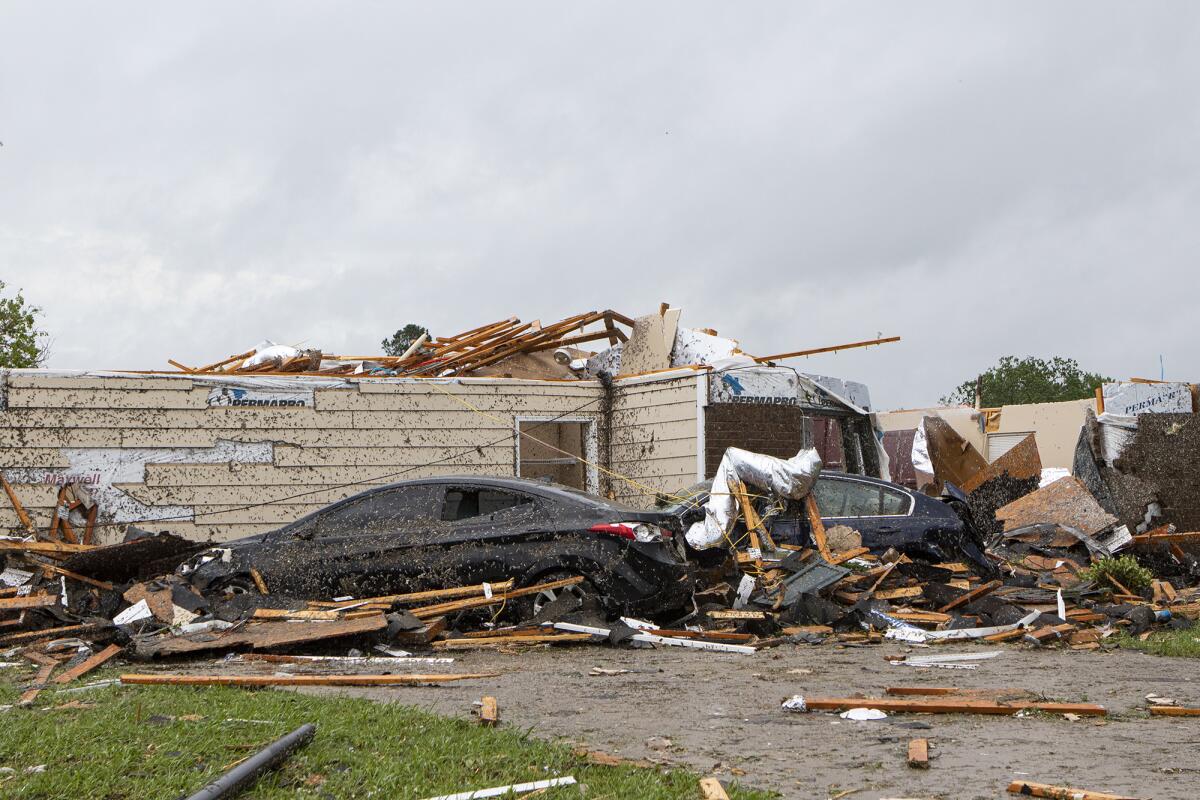 A tornado ripping through Monroe, La., tore off this home's roof just before noon Sunday while also causing extensive damage in the neighborhood and at the regional airport.