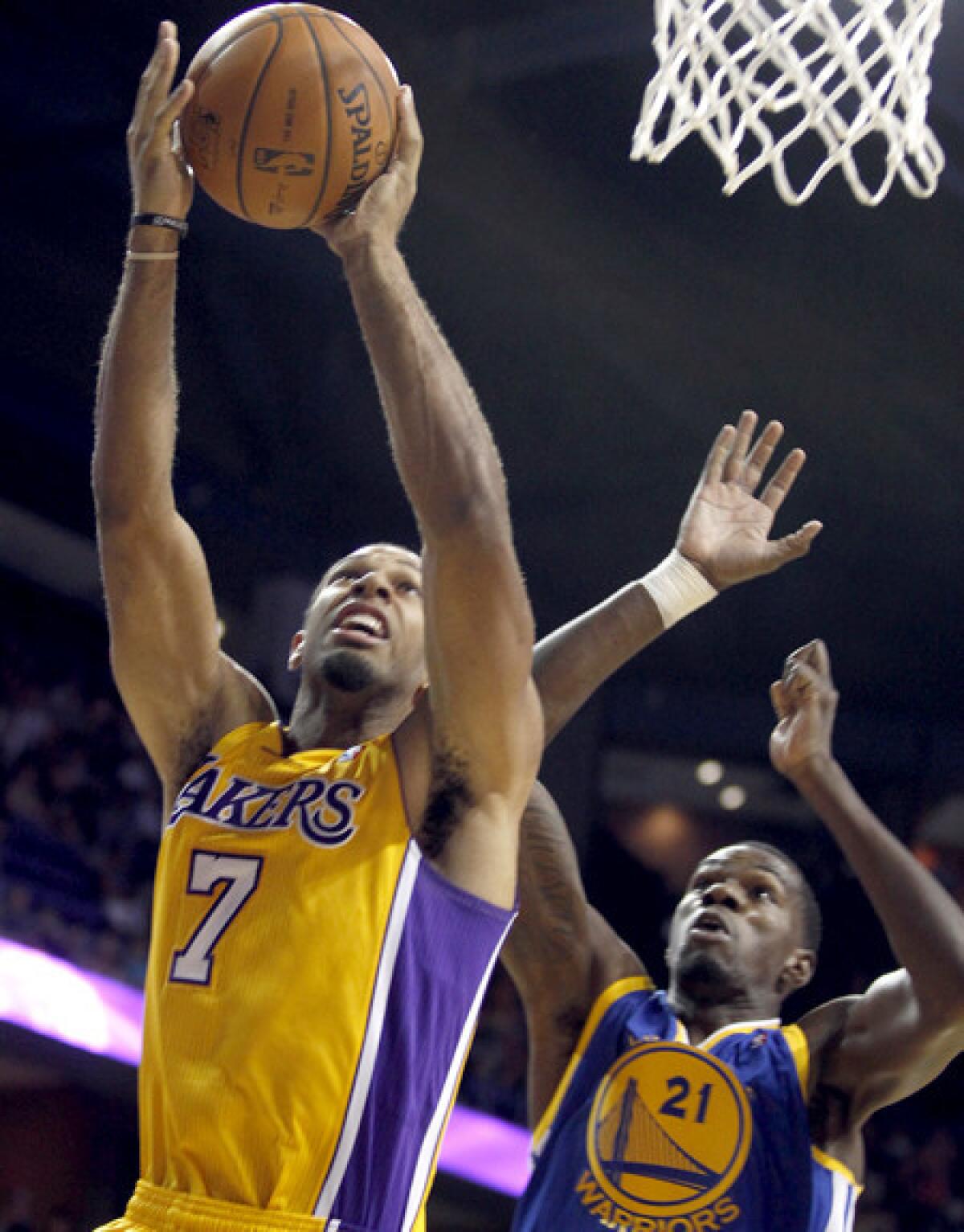 Lakers guard Xavier Henry scores against Warriors center Dewayne Dedmon in the third quarter Saturday night.