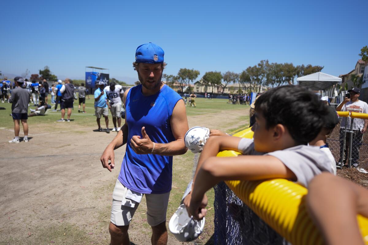 Rams quarterback Matthew Stafford signs autographs after a joint NFL practice with the Dallas Cowboys Wednesday.