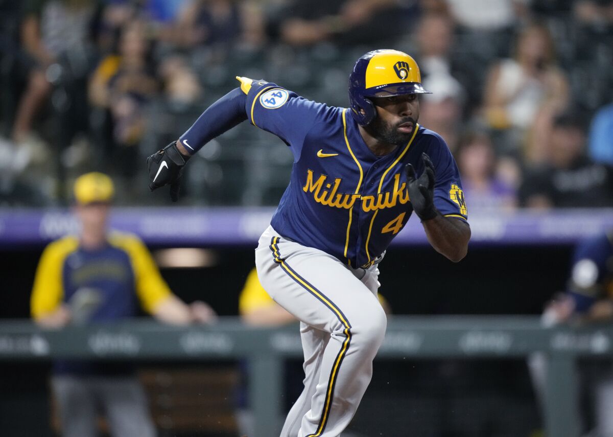 FILE - Milwaukee Brewers' Jackie Bradley Jr. heads toward first during the team's baseball game against the Colorado Rockies on June 18, 2021, in Denver. The Boston Red Sox acquired Bradley from Milwaukee in a trade that sent outfielder Hunter Renfroe to the Brewers on Wednesday night, Dec. 1. (AP Photo/David Zalubowski, File)