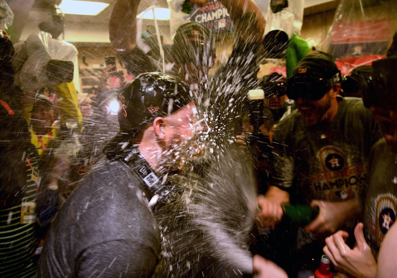 Astro players spray champagne in the clubhouse.