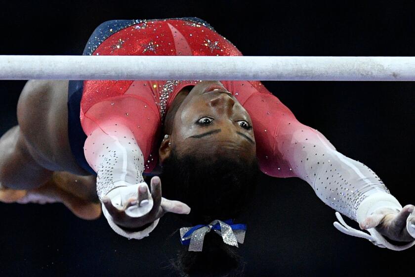USA's Simone Biles performs on the uneven bars during the women's team final at the FIG Artistic Gymnastics World Championships at the Hanns-Martin-Schleyer-Halle in Stuttgart, southern Germany, on October 8, 2019. (Photo by THOMAS KIENZLE / AFP) (Photo by THOMAS KIENZLE/AFP via Getty Images) ** OUTS - ELSENT, FPG, CM - OUTS * NM, PH, VA if sourced by CT, LA or MoD **