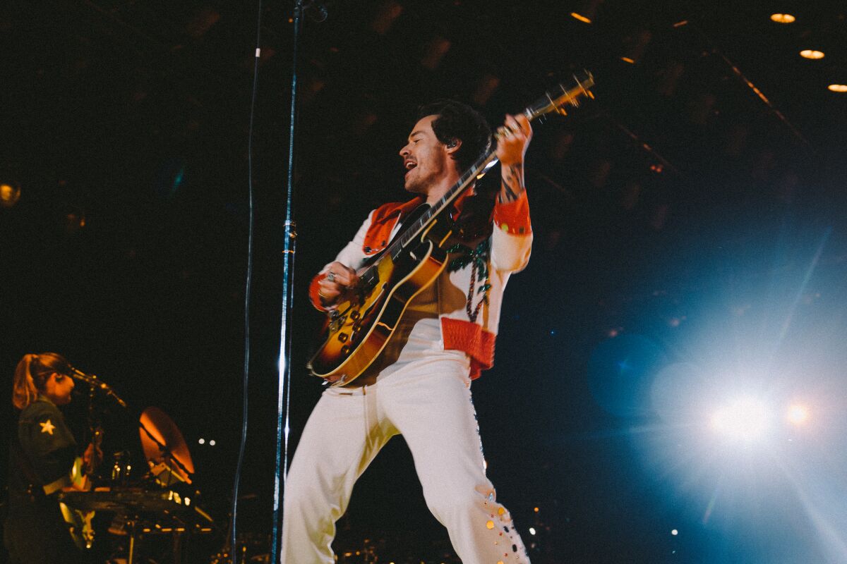 A man plays guitar onstage