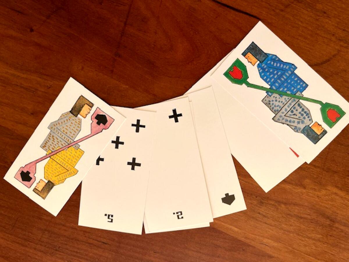 Several playing cards spread on a table.
