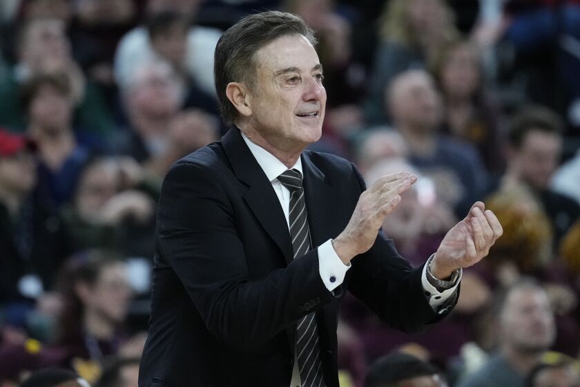 Iona head coach Rick Pitino claps his hands during the second half of an NCAA college basketball game