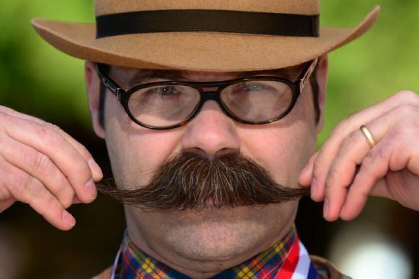 Adam Orcutt from Michigan City, Ind., poses after winning first place in the Natural Moustache category at the third annual National Beard and Moustache Championships in Las Vegas on November 11, 2012.